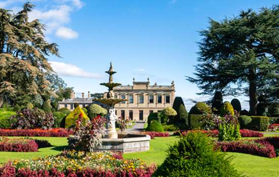 The gardens with view of Brodsworth Hall on a sunny day.