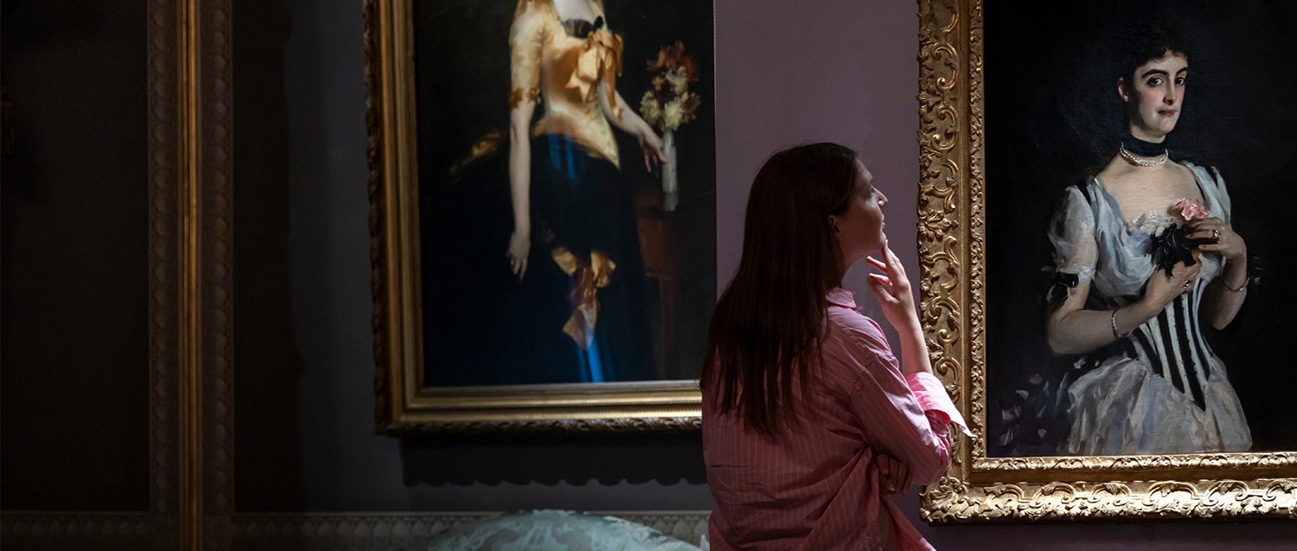 A young woman looks at a portrait of a glamorous young woman (Mrs Wilton Phipps by John Singer Sargent)